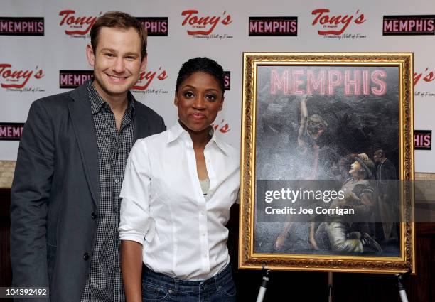 Actors Chad Kimball and Montego Glover attend the "Memphis" cast portrait unveiling at Tony's di Napoli on September 23, 2010 in New York City.