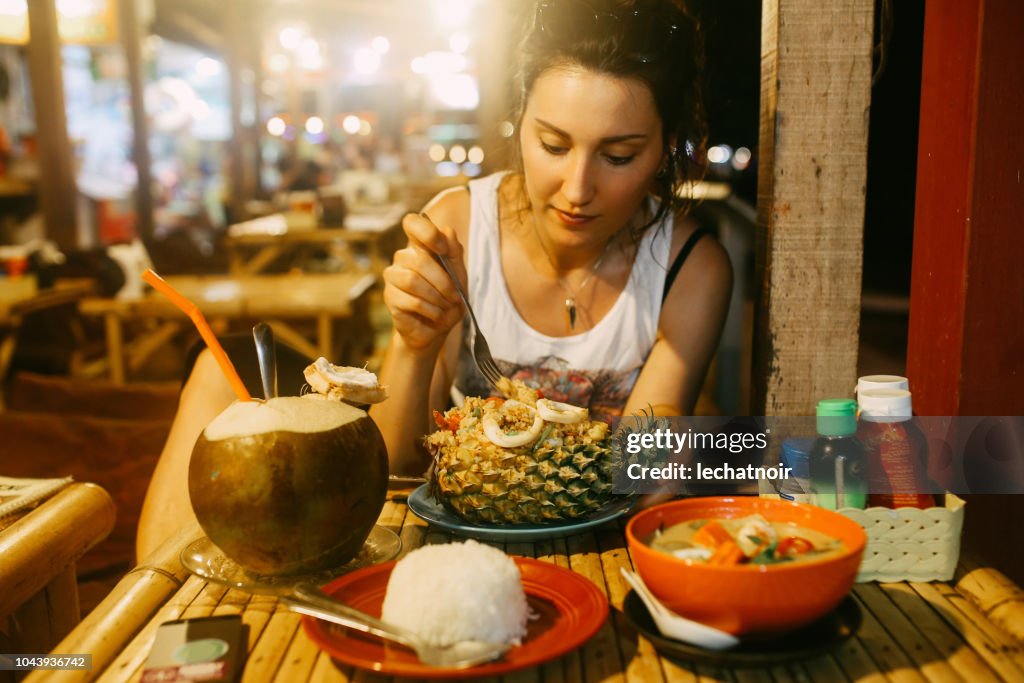 Pad Thai with shrimps served in a pineapple and a coconut water juice