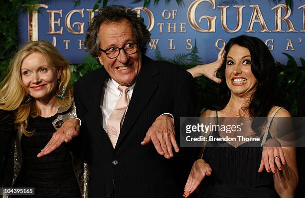 Essie Davis, Geoffrey Rush and associate producer Katrina Peers make the gesture of a flying owl at the Australian Premiere of "Legends Of The...