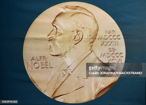 Portrait of Swedish inventor and scholar Alfred Nobel can be seen on a banner on display at the Nobel Forum in Stockholm, Sweden, prior to a press...