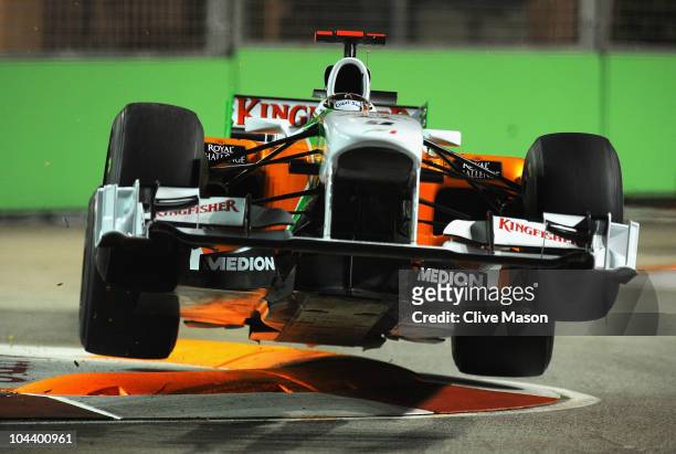 Adrian Sutil of Germany and Force India goes airborne as he hits a curb during practice for the Singapore Formula One Grand Prix at the Marina Bay...