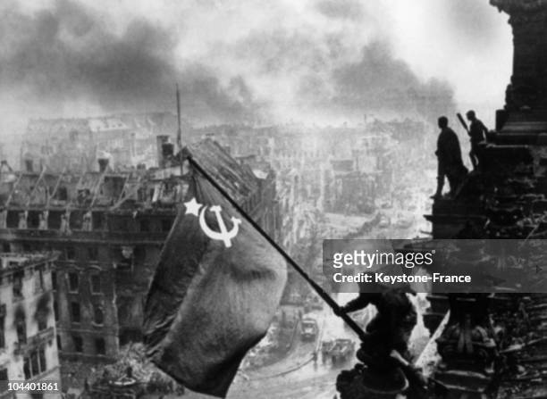 Russian sergeant KOVALIOV, and another comrade, raising the Russian flag onto the Reichstag while below them Berlin burns. The real identity of these...