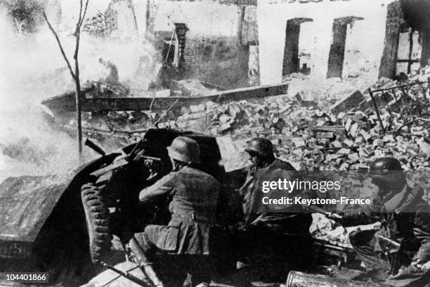 During the Battle of Stalingrad, German soldiers use an antitank cannon in a street of the city.