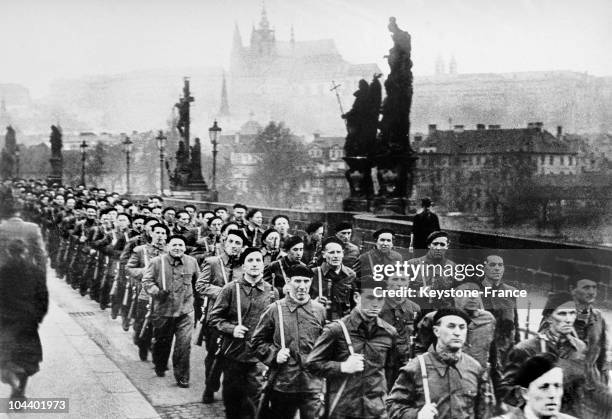 Communists taking power in Czechoslovakia. Members of the Czech popular militia crossing the Charles IV bridge. In the background can be seen the...