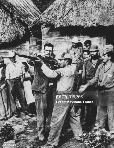 Fidel CASTRO giving firing instructions to guerrilla fighters who have come to join his armed forces in the Sierra Maestra, a mountainous region in...