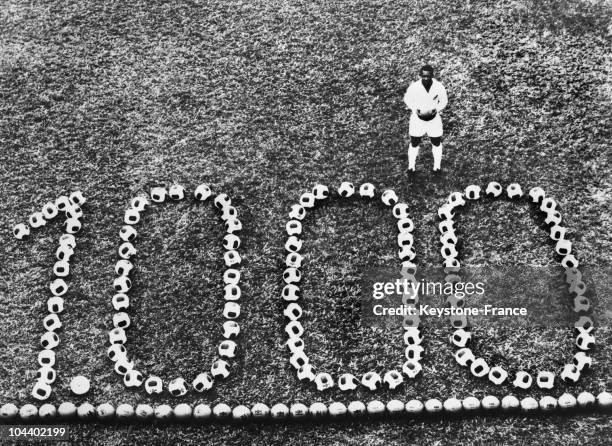 The famous Brazilian football player celebrating his 1000th goal in front of the triumphant number formed by footballs.