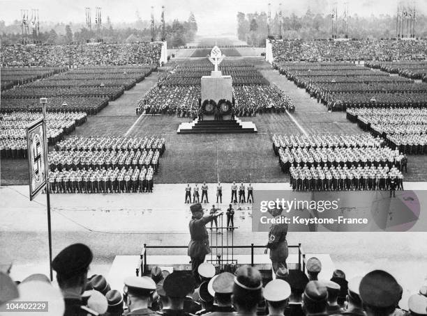 Chief of the Reich work program and the Führer Adolf HITLER making the Nazi salute at the tribune of the Nuremberg Rally, the 8th national congress...