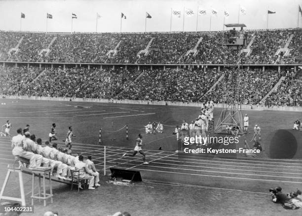 Jesse OWENS at the finish line. He broke the 100-meter world record with a time of 10 seconds 2/10th in the Olympic Stadium in Berlin. At the end of...