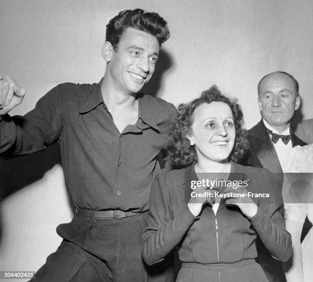 Around 1945, at the Petits Lits Blancs bal in Paris, Edith PIAF and her current partner Yves MONTAND pose together before beginning their singing...