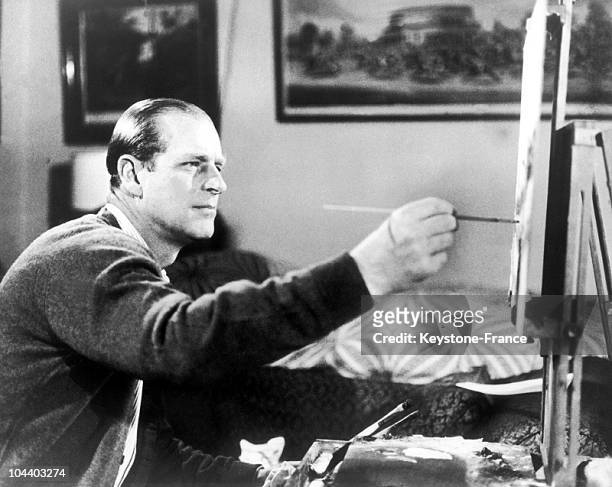 The Duke of EDINBURGH seen working at one of his lesser known hobbies, painting - during the shooting of a film on the royal family, on June 19, 1969.