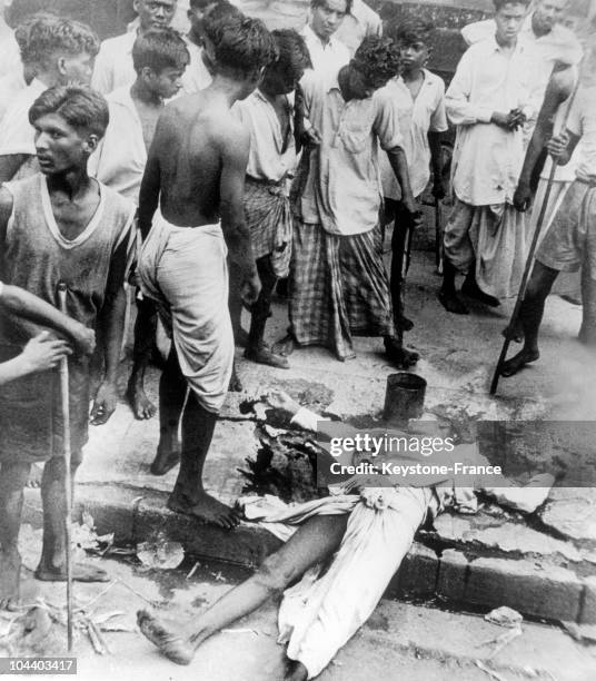 August 1946 in Calcutta , an Indian lies dead on the sidewalk post Hindu-Muslim riots. The riots, numbering 4000 dead, were provoked by the Muslim...