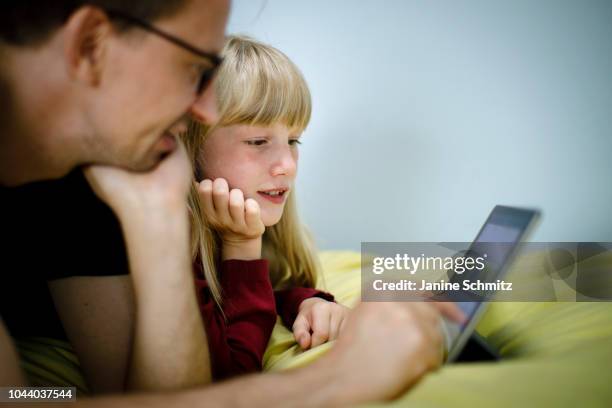 Father and a child are working on a tablet together on August 14, 2018 in Berlin, Germany.