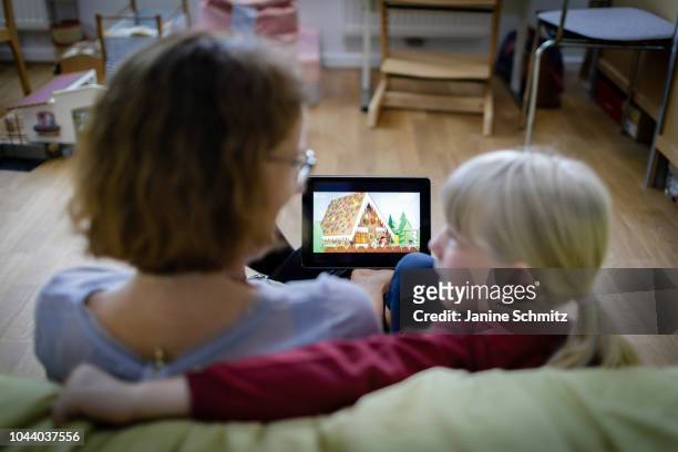 Woman and a child are watching a movie on a tablet on August 14, 2018 in Berlin, Germany.