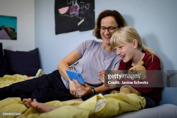 Woman and a child are using a smartphone together on August 14, 2018 in Berlin, Germany.