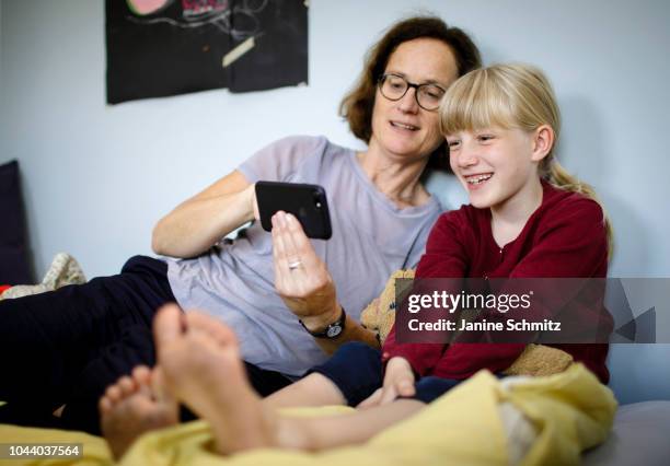 Woman and a child are using a smartphone together on August 14, 2018 in Berlin, Germany.