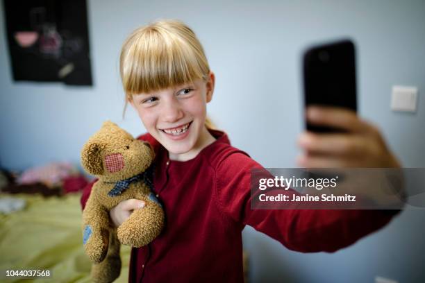 Girl is taking a Selfie of herself and her teddy bear on August 14, 2018 in Berlin, Germany.