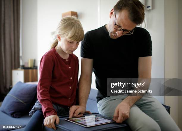 Father and a child are using a tablet together on August 14, 2018 in Berlin, Germany.