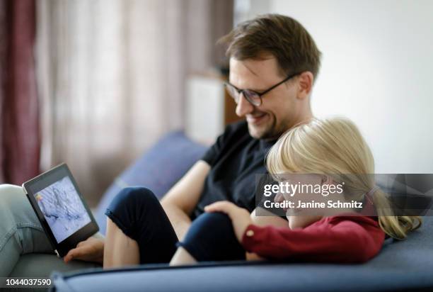 Father and a child are using a tablet together on August 14, 2018 in Berlin, Germany.