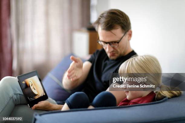 Father and a child are using a tablet together on August 14, 2018 in Berlin, Germany.