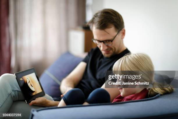 Father and a child are using a tablet together on August 14, 2018 in Berlin, Germany.