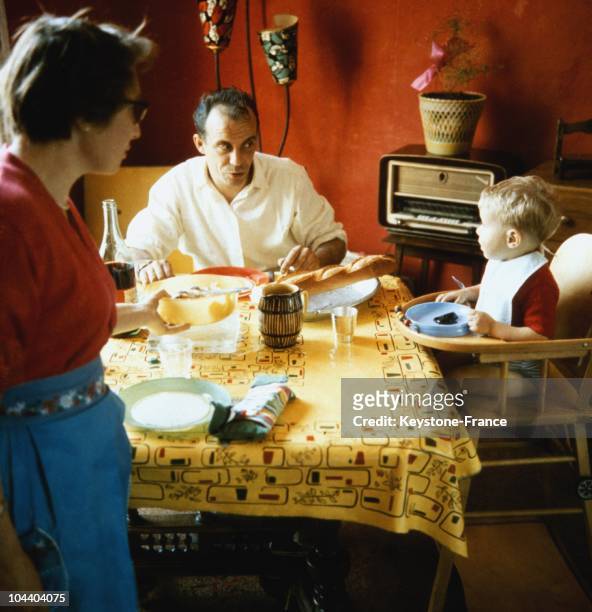 Couple and their child eating together in their dining room in the 1960's.