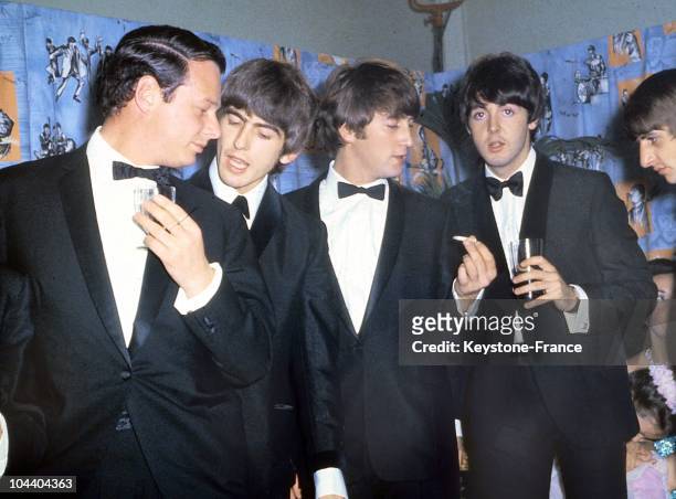 Portrait of the BEATLES with their manager Brian EPSTEIN, wearing dinner jackets at a reception between 1964 and 1966.