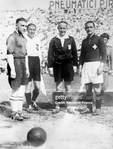 Second soccer World Cup in Florence, Italy. Captains of the Swiss and Dutch teams surounding the referee and a Dutch player during a...