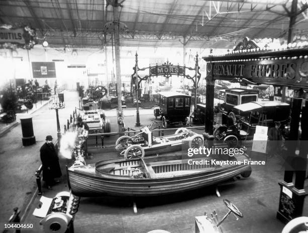 Presenting a boat among its cars on its stand, Paris Car Show, at the Grand Palais.