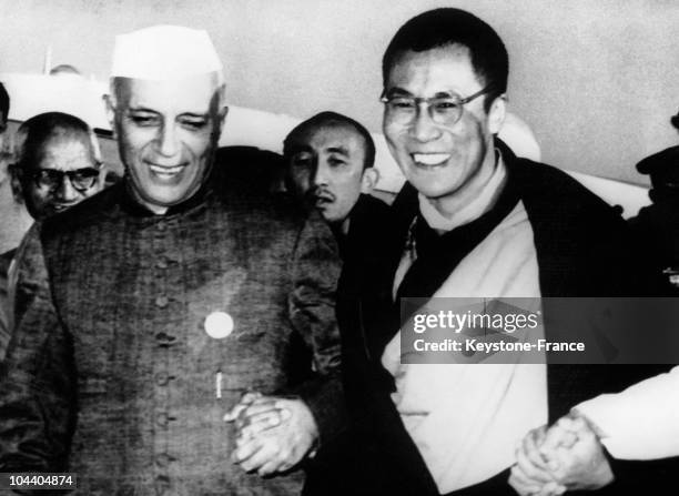 The DALAI-LAMA welcomed by the Indian prime minister NEHRU on his arrival to Delhi airport where they celebrated the 2, 500th anniversary of Buddhism...