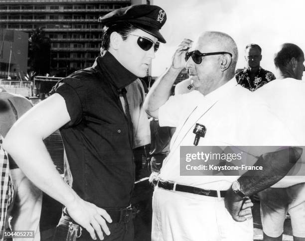 In the Hawaiian island, the American singer/actor Elvis PRESLEY, wearing a policeman's uniform and speaking with the American film director Norman...