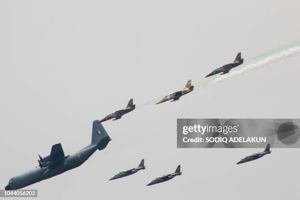 Nigerian Air Force planes perfom during a military parade marking the country's 58th anniversary of independence, on October 1 on Eagle Square in...