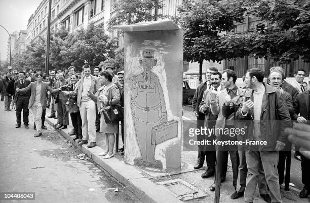On the Boulevard Kellerman in Paris, protesters on their way to Charlety stadium display a caricatural poster of General DE GAULLE hitchiking to...