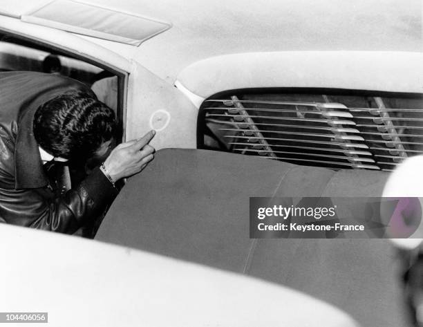 At the Police Headquarters of Paris, an inspector of the judicial police examined President Charles DE GAULLE's car, which had been riddled with...