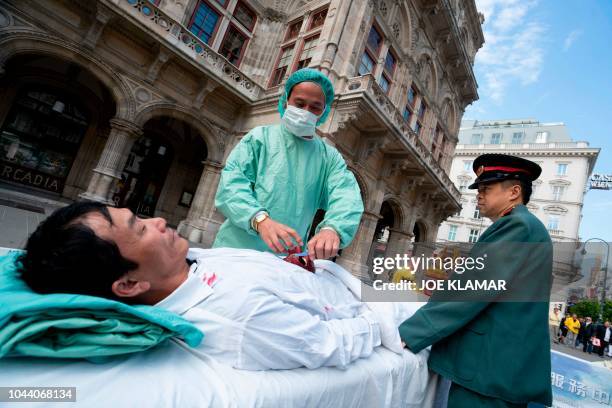 Up to three hundred supporters of the practice of Falun Dafa march through the city center of Vienna, Austria on October 1, 2018 to protest against...