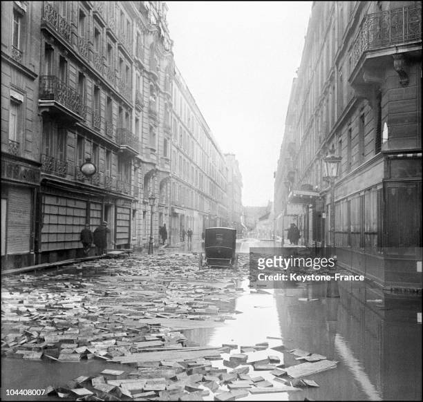 Following the great Paris flood and the overflowing of the Seine, wooden paving blocks can be seen scattered on the ground which is still covered...
