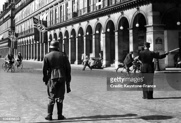 This German soldier is on guard in the middle of rue Rivoli in front of rue Castiglione and the Intercontinental Hotel where the Gestapo has its...