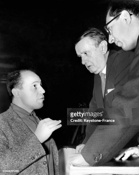In the Paris Opera House, the French composers Pierre BOULEZ and Georges AURIC are having a talk during the rehearsals of WOZZECK, an opera written...