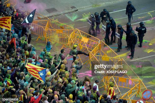 Protesters try to break a security barrier as they gather in front of the Spanish Govenment's local office in Girona on October 1, 2018 during the...