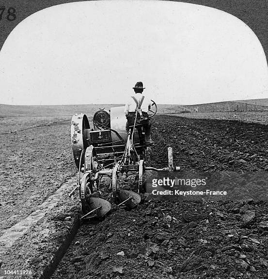 South Dakota around 1900, one tractor do the work of nine horses. Three plows are turning over the black earth.