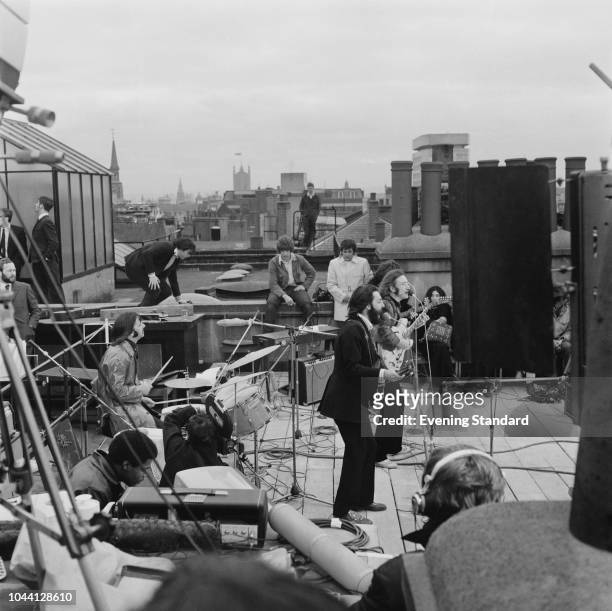 British rock group the Beatles performing their last live public concert on the rooftop of the Apple Organization building for director Michael...