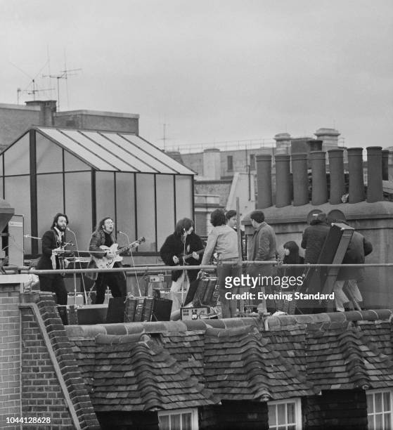 British rock group the Beatles performing their last live public concert on the rooftop of the Apple Organization building for director Michael...