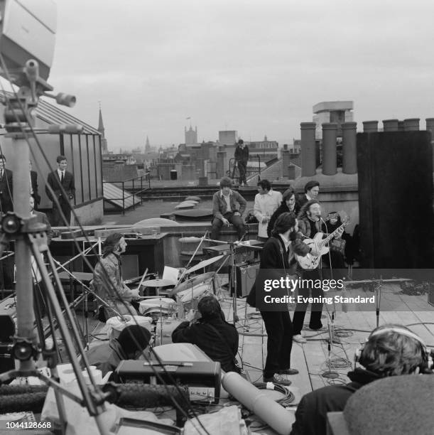 British rock group the Beatles performing their last live public concert on the rooftop of the Apple Organization building for director Michael...