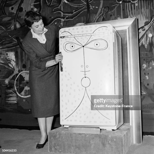 Presenting a refridgerator decorated by Jean COCTEAU at the exhibition NOBLESSES DE L'OBJET QUOTIDIEN in Paris on June 26, 1958.