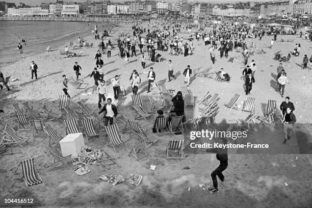 Mods invading the beach during an outbreak of violence with groups of rockers at Margate, Kent, 18th May 1964.