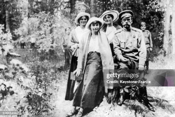 Czar NICOLAS II between his daughters MARIA, ANASTASI and OLGA , held prisoner by the Red Guards in Siberia a few days prior to their assassination...