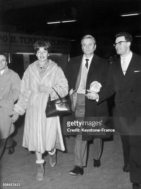 American actress Rita Hayworth arriving at a railway station in Rome, with her husband, film producer James Hill, circa 1960.