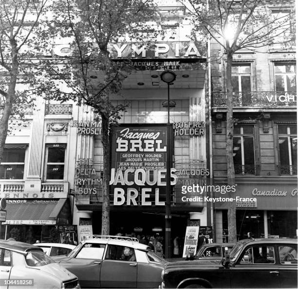 The entrance to the Olympia Music Hall on the Boulevard des Capucines in the ninth district of Paris which showing the Belgian singer Jacques Brel on...