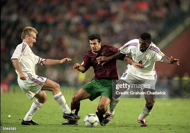 Luis Figo of Portugal takes on Didier Deschamps and Marcel Desailly of France during the European Championships 2000 semi-final at the King Baudouin...