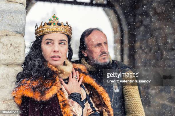 portrait of queen with his warrior in front of her castle - medieval queen crown imagens e fotografias de stock