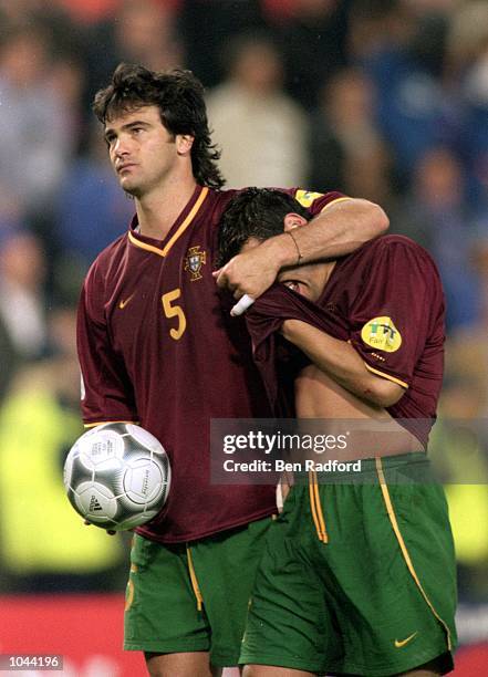 Fernando Couto of Portugal consoles teammate Sergio Conceicao during the European Championships 2000 semi-final against France at the King Baudouin...